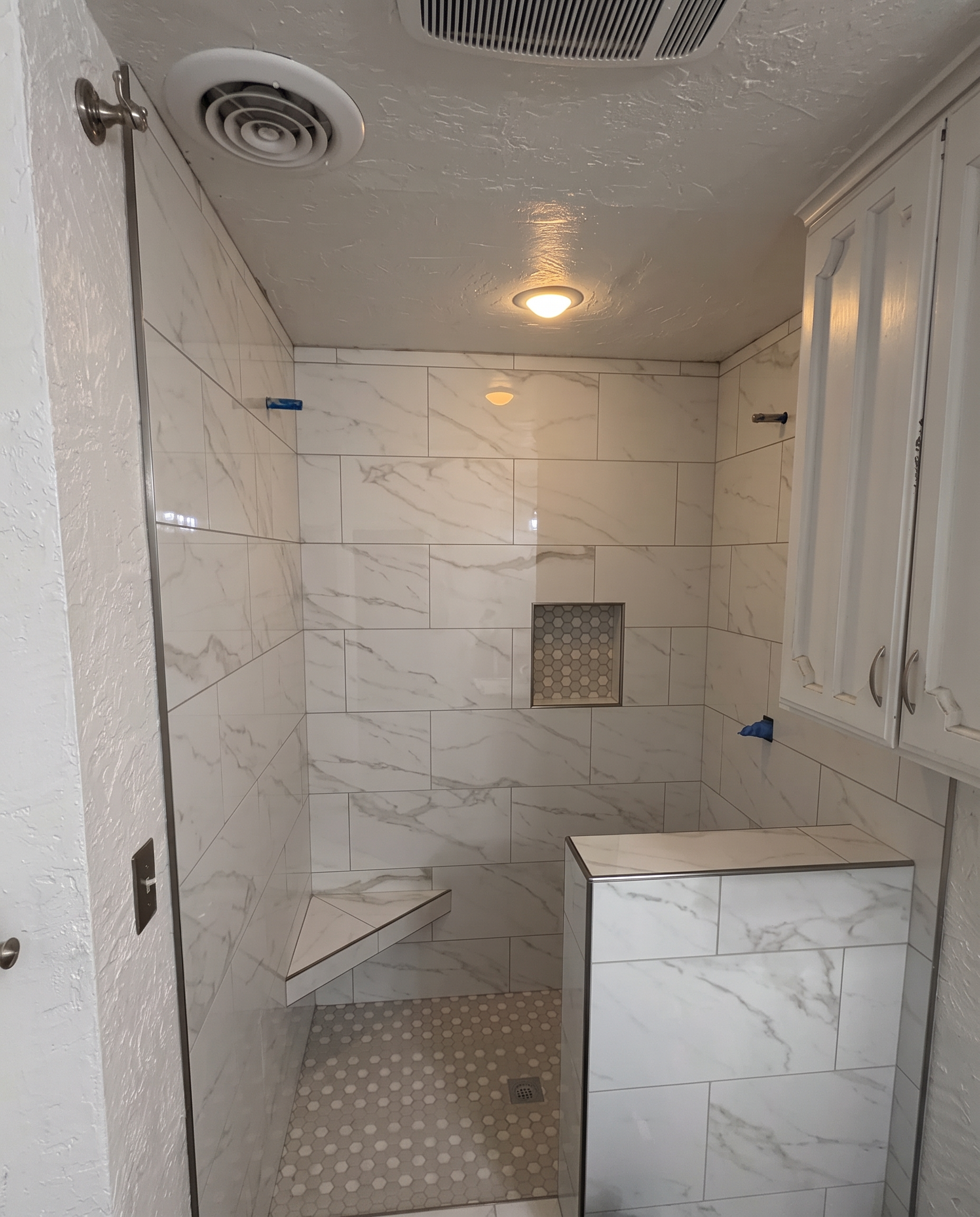 New marble-look tile walk-in shower after the remodel